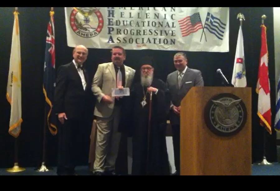 District 20 Governor Wynn Storton, presents check to Acrbishop Demeitrius at the 2015 Supreme Convention.